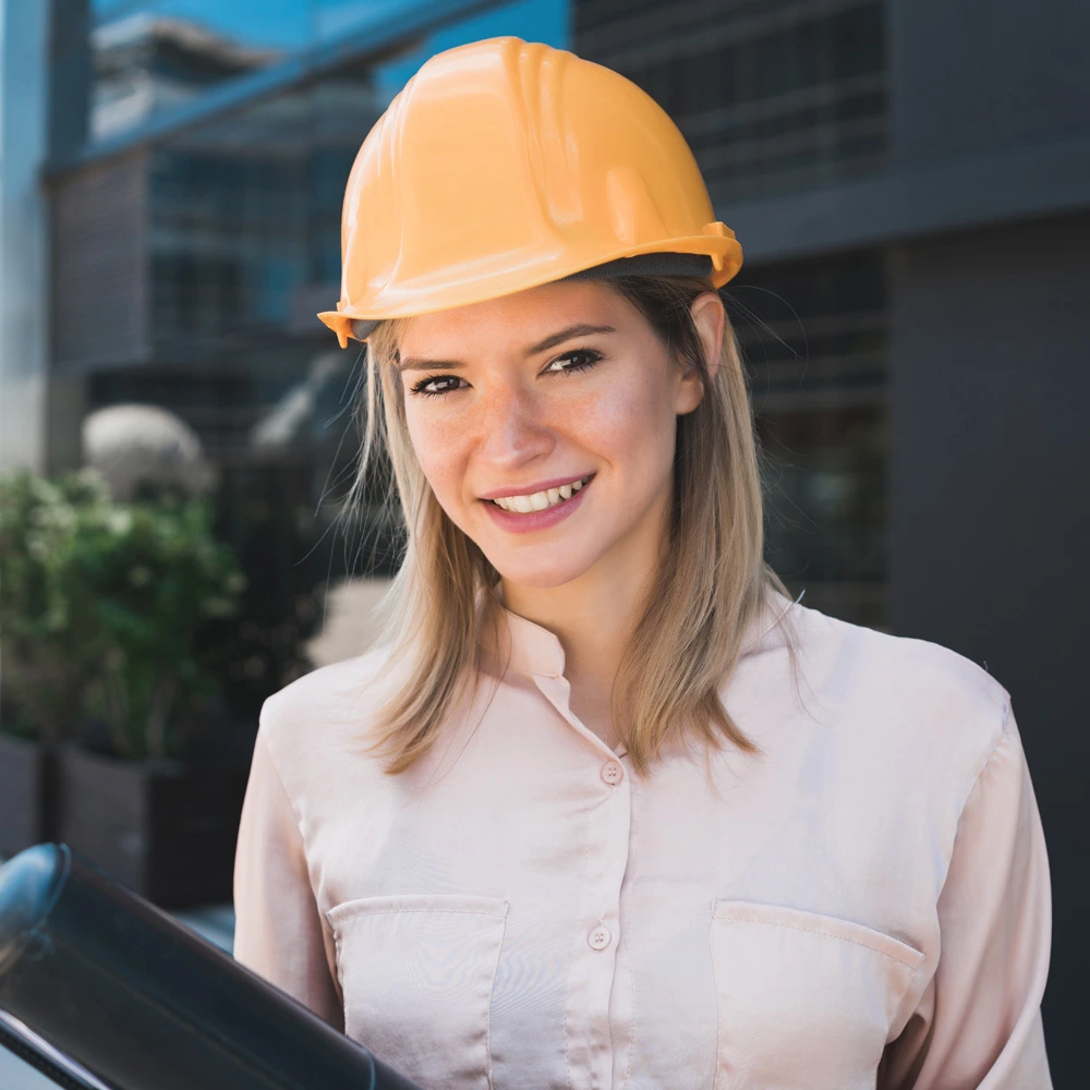 female smiling and wearing yellow helmet